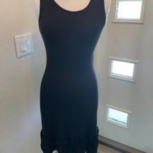 Simple black dress with subtle rose along hem